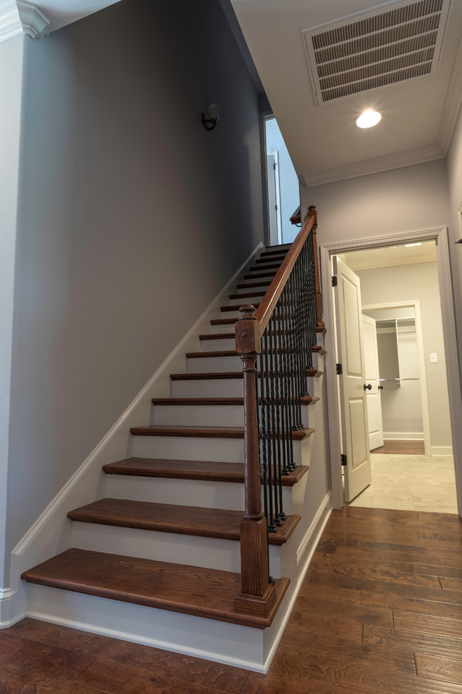 Inspiration for a mid-sized transitional painted straight staircase remodel with wooden risers