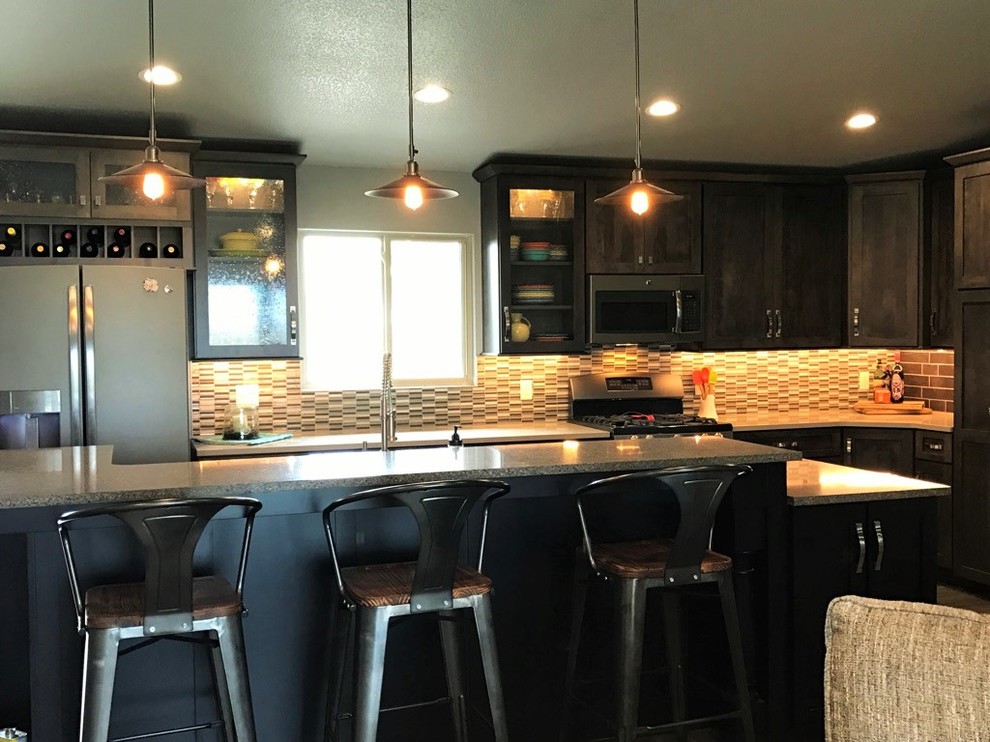 Open concept kitchen - mid-sized transitional single-wall light wood floor open concept kitchen idea with shaker cabinets, dark wood cabinets, multicolored backsplash, glass tile backsplash, stainless steel appliances, an island, a farmhouse sink and granite countertops