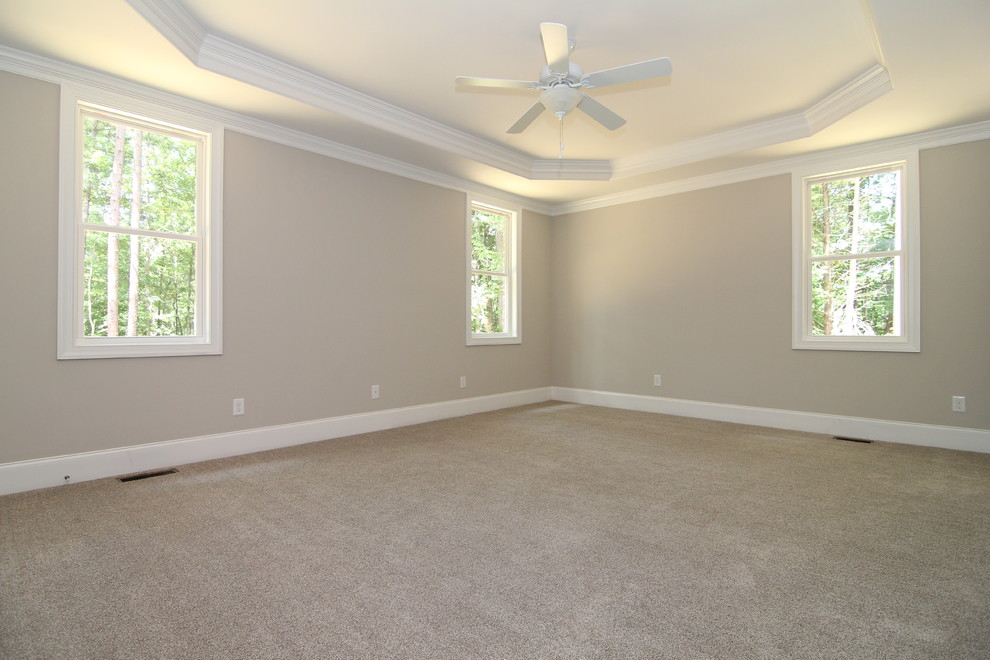 Mid-sized transitional master bedroom in Raleigh with grey walls and carpet.
