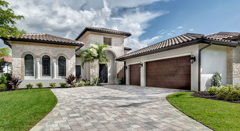 Large mediterranean two-storey beige exterior in Miami with mixed siding.