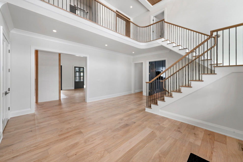 Huge transitional light wood floor and brown floor foyer photo in Chicago with gray walls
