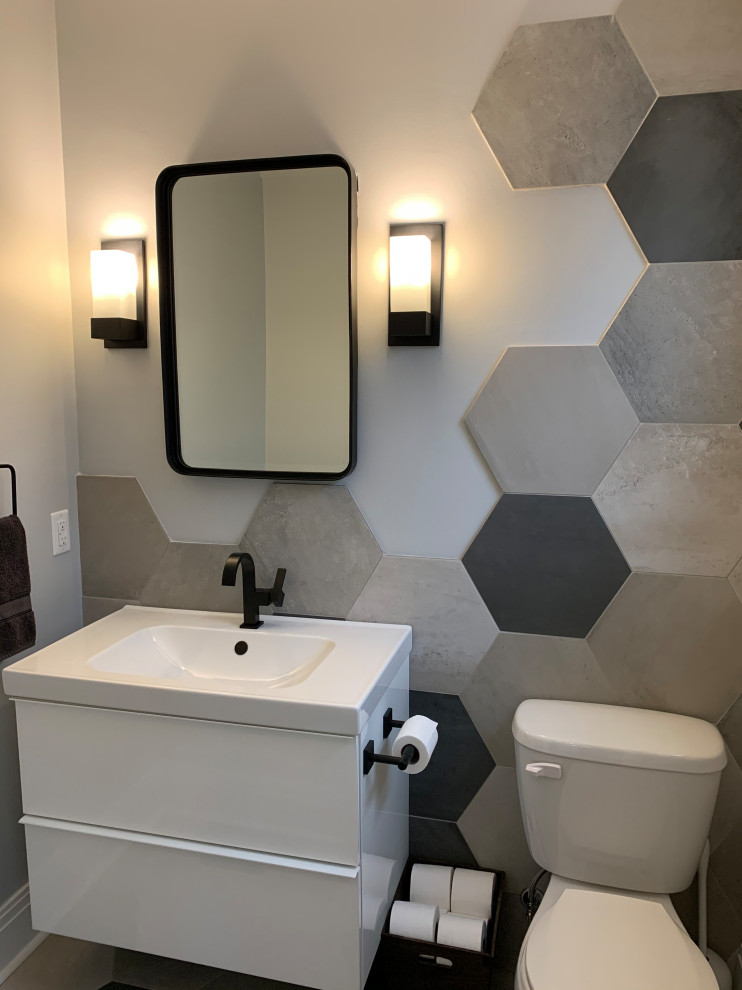 Photo of a small contemporary cloakroom in Other with flat-panel cabinets, white cabinets, a two-piece toilet, grey tiles, porcelain tiles, grey walls, ceramic flooring, an integrated sink, solid surface worktops, grey floors, white worktops and a floating vanity unit.