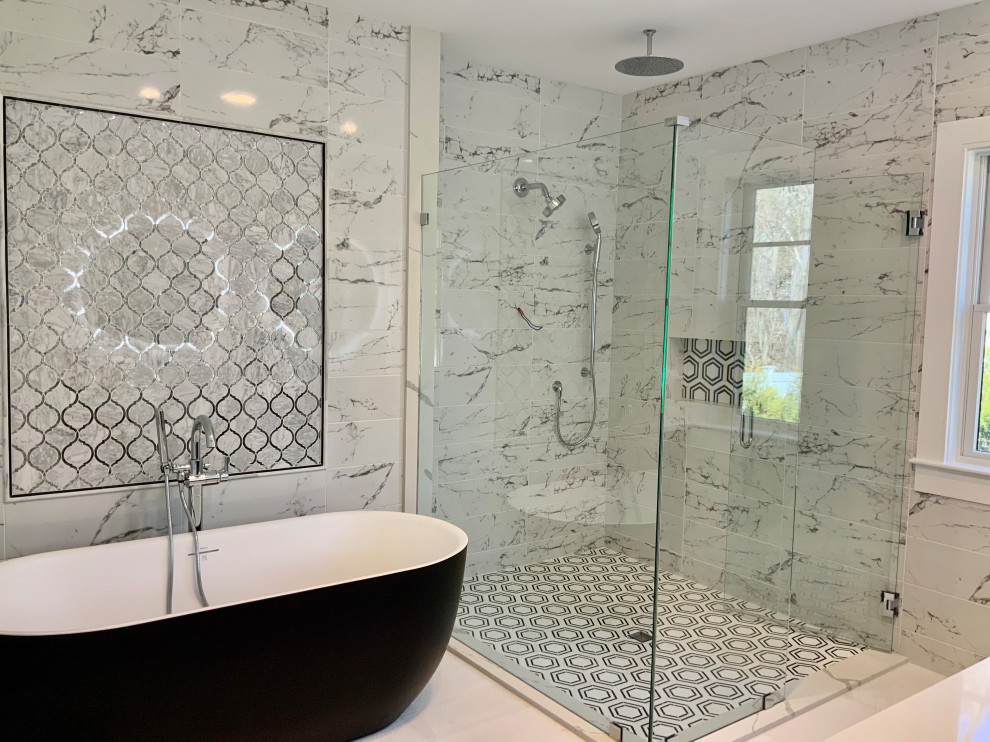 Photo of a large country master bathroom in Boston with a freestanding tub, a curbless shower, black and white tile, ceramic tile, white walls, cement tiles, white floor, a hinged shower door and a niche.