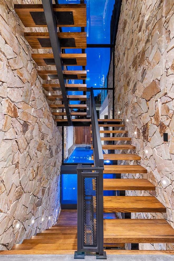 Inspiration for a large contemporary wood u-shaped staircase in Adelaide with open risers and metal railing.