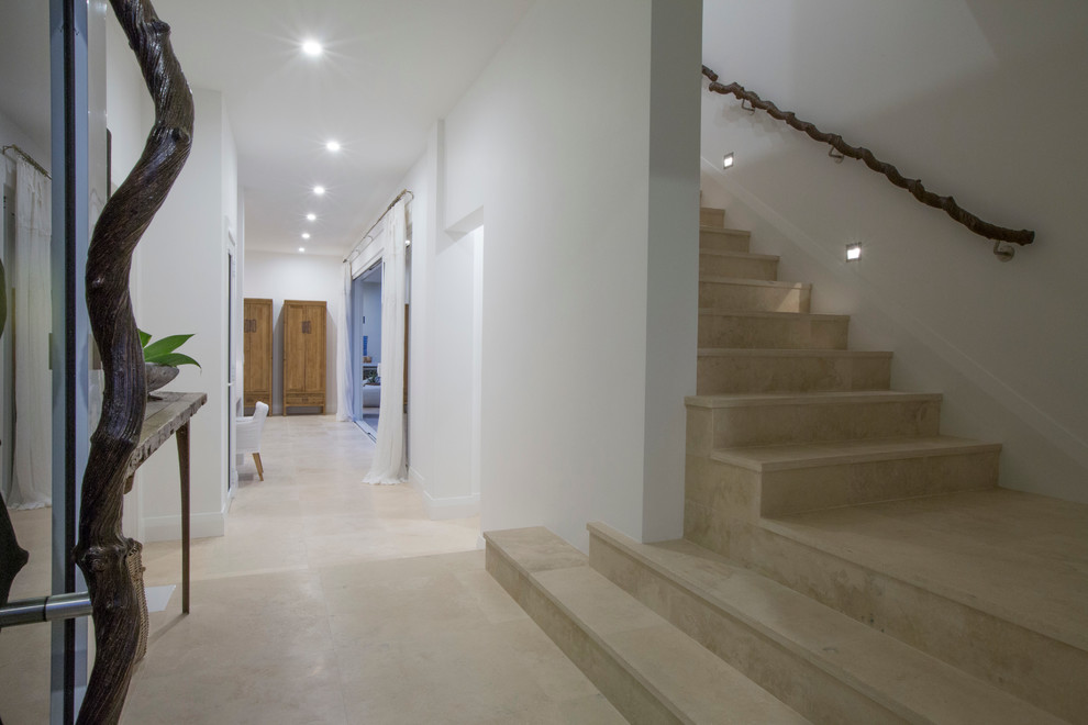 Design ideas for a mid-sized beach style travertine l-shaped staircase in Perth with travertine risers.