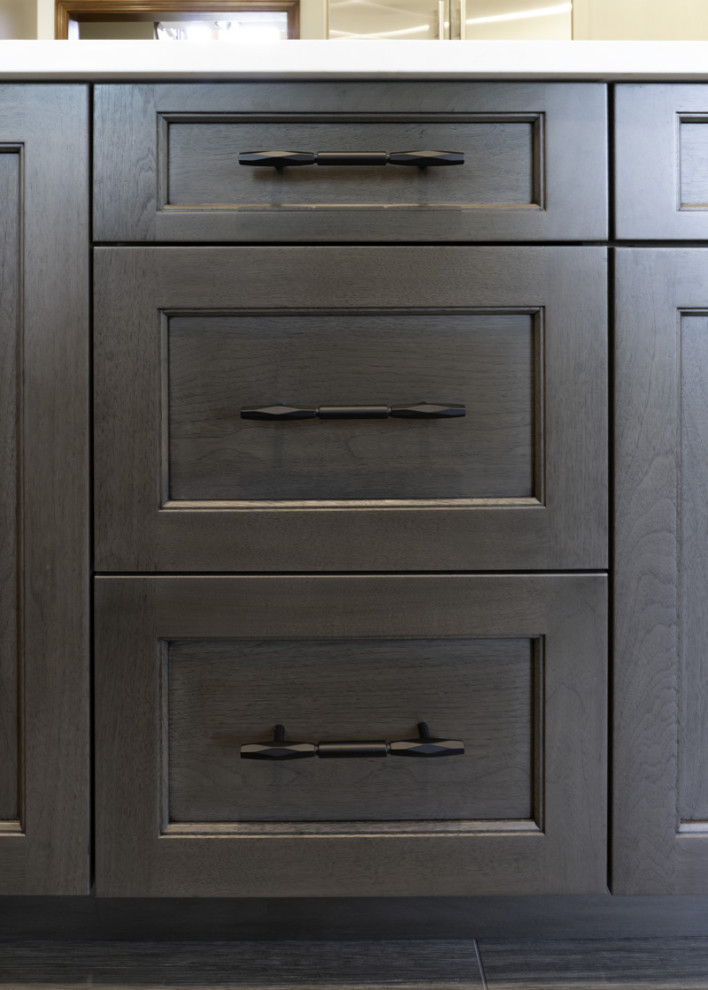 Large transitional porcelain tile and gray floor eat-in kitchen photo in Chicago with a farmhouse sink, recessed-panel cabinets, light wood cabinets, quartz countertops, gray backsplash, porcelain backsplash, an island and white countertops