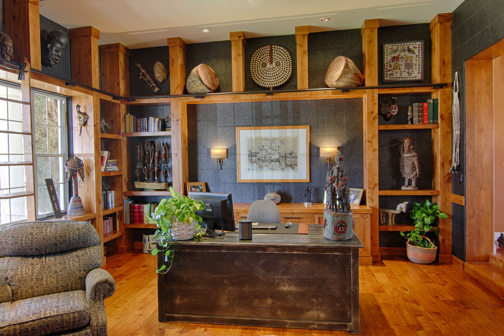 Inspiration for a study room in Phoenix with black walls, medium hardwood floors and a freestanding desk.