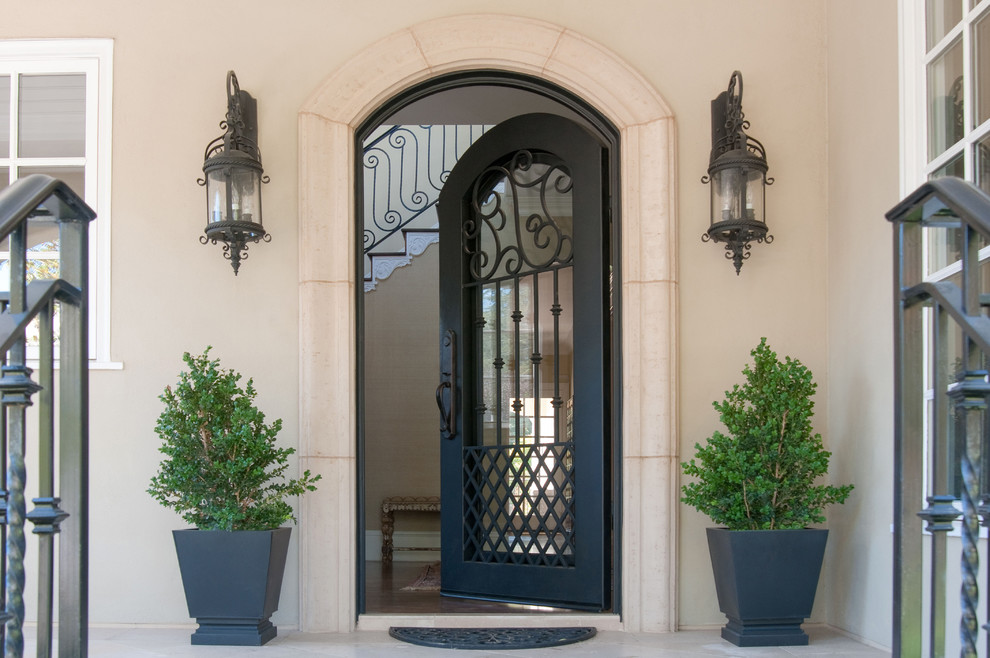 This is an example of a large traditional front door in San Francisco with beige walls, a single front door and a black front door.