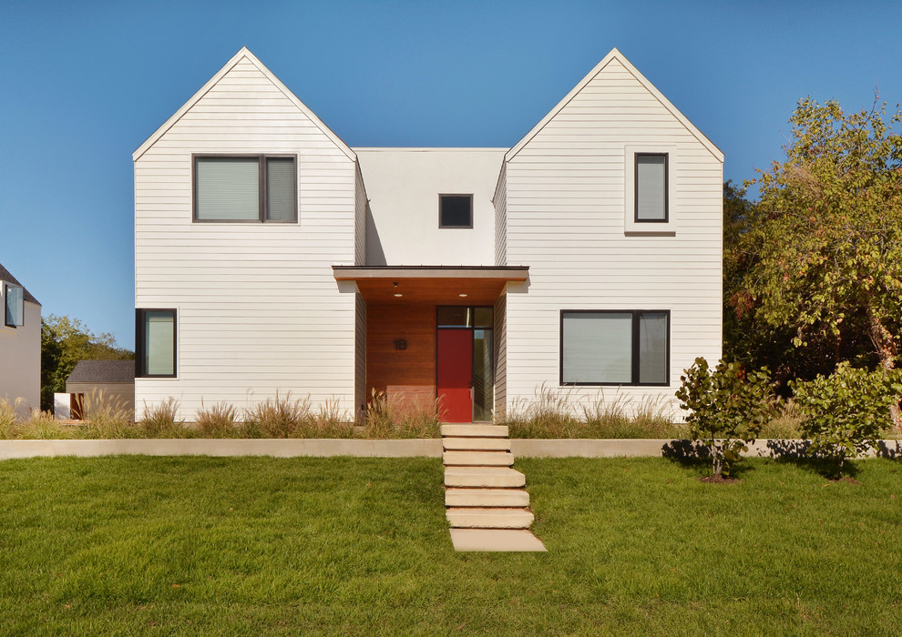 Example of a trendy white exterior home design in Austin