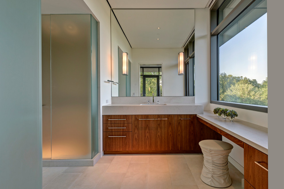 Design ideas for a mid-sized modern master bathroom in Austin with flat-panel cabinets, dark wood cabinets, a two-piece toilet, white walls, limestone floors, an undermount sink, concrete benchtops and beige floor.