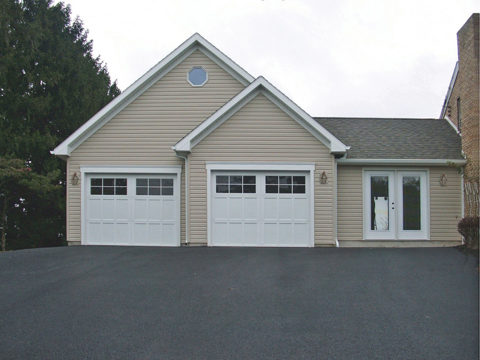 This is an example of a mid-sized country attached two-car garage in Other.