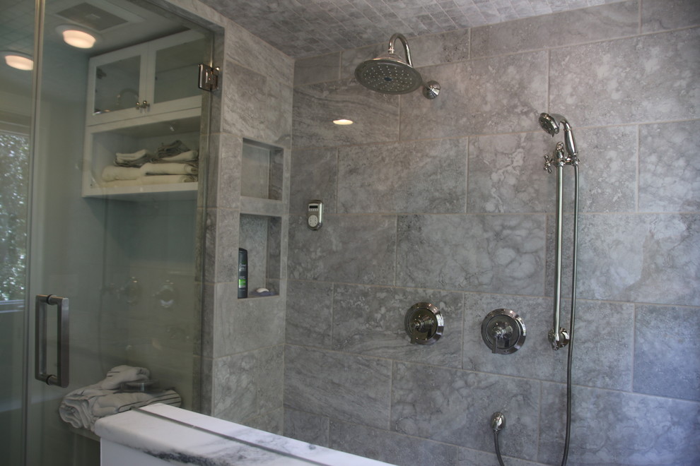Example of a mid-sized transitional master stone tile marble floor double shower design in Charlotte with flat-panel cabinets, white cabinets, a two-piece toilet, an undermount sink and marble countertops