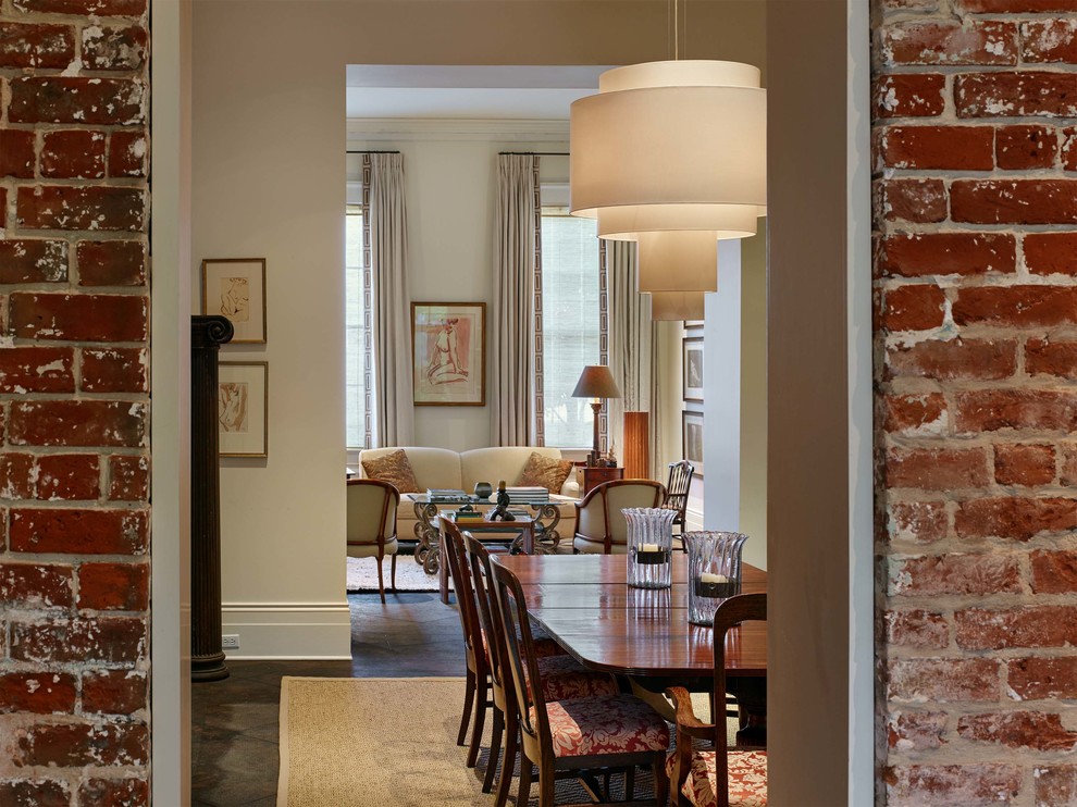 Design ideas for a large transitional separate dining room in New Orleans with white walls, concrete floors, a standard fireplace, a brick fireplace surround and white floor.