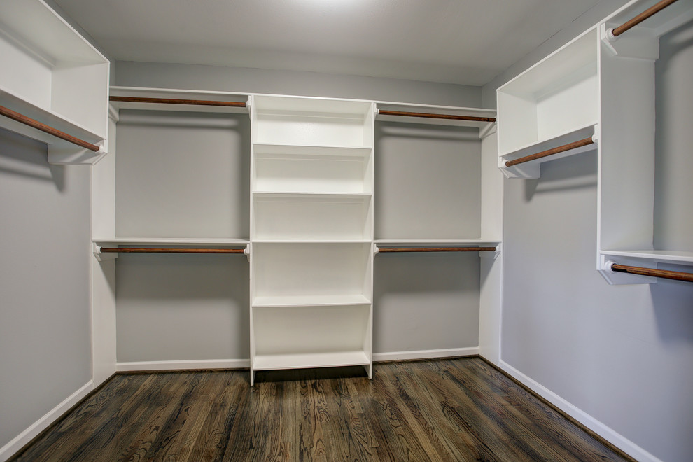 Inspiration for a modern gender-neutral dark wood floor walk-in closet remodel in Houston with open cabinets and white cabinets