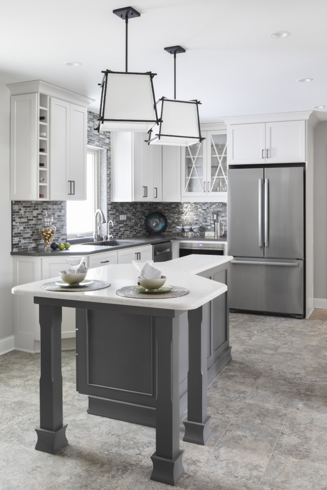 Design ideas for a large transitional u-shaped eat-in kitchen in Milwaukee with an undermount sink, shaker cabinets, white cabinets, quartz benchtops, grey splashback, stone tile splashback, stainless steel appliances, vinyl floors, with island, grey floor and grey benchtop.