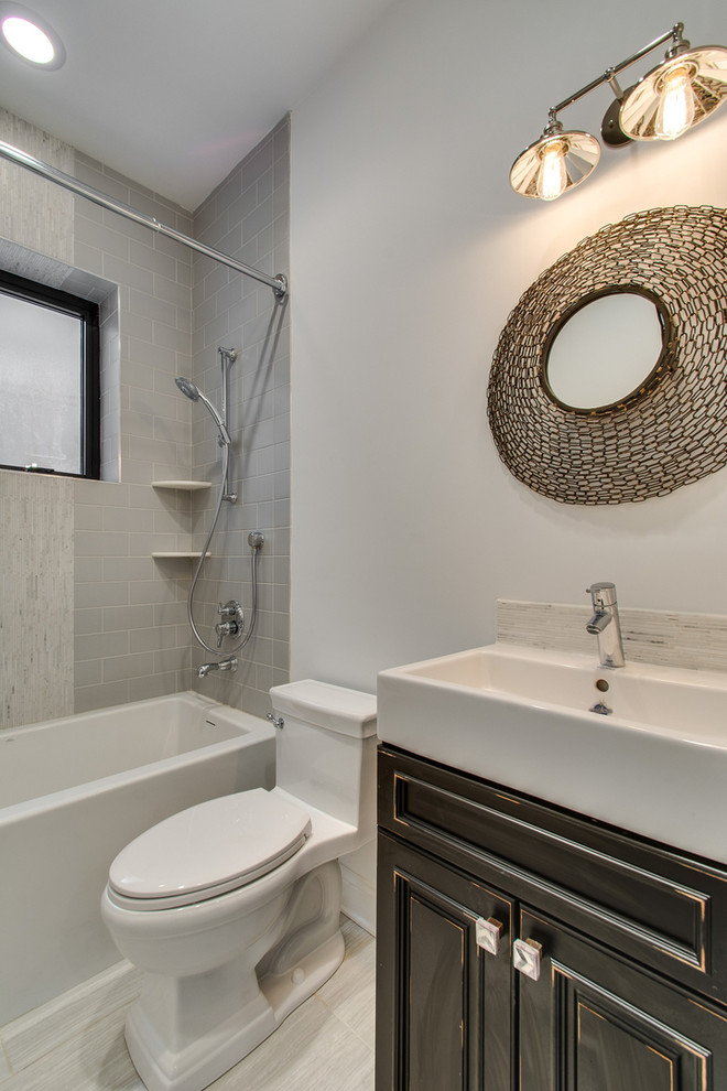 Inspiration for a mid-sized transitional 3/4 bathroom in Chicago with raised-panel cabinets, distressed cabinets, an alcove shower, a one-piece toilet, gray tile, subway tile, white walls, porcelain floors, a trough sink, white floor and a hinged shower door.