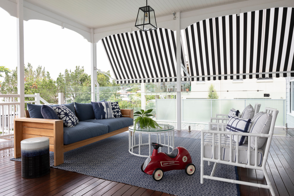Mid-sized transitional backyard verandah in Brisbane with decking and a roof extension.