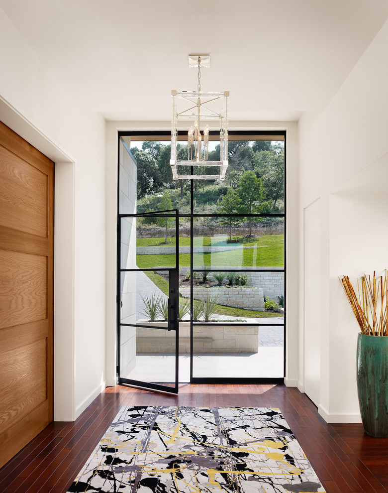 Inspiration for a contemporary entryway in Austin with a glass front door.