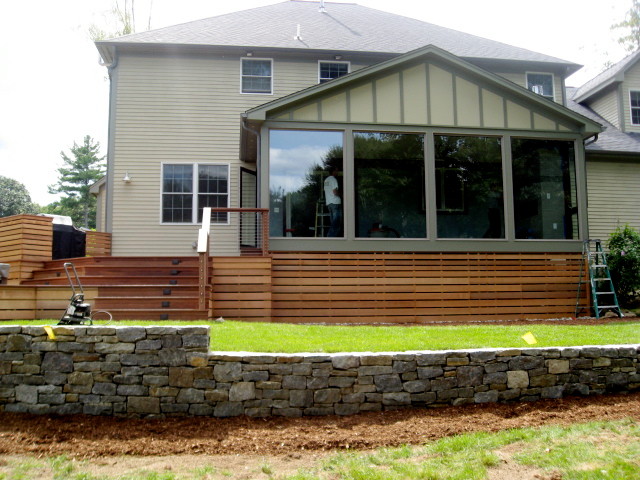 Design ideas for a large contemporary backyard deck in Providence with a water feature and no cover.