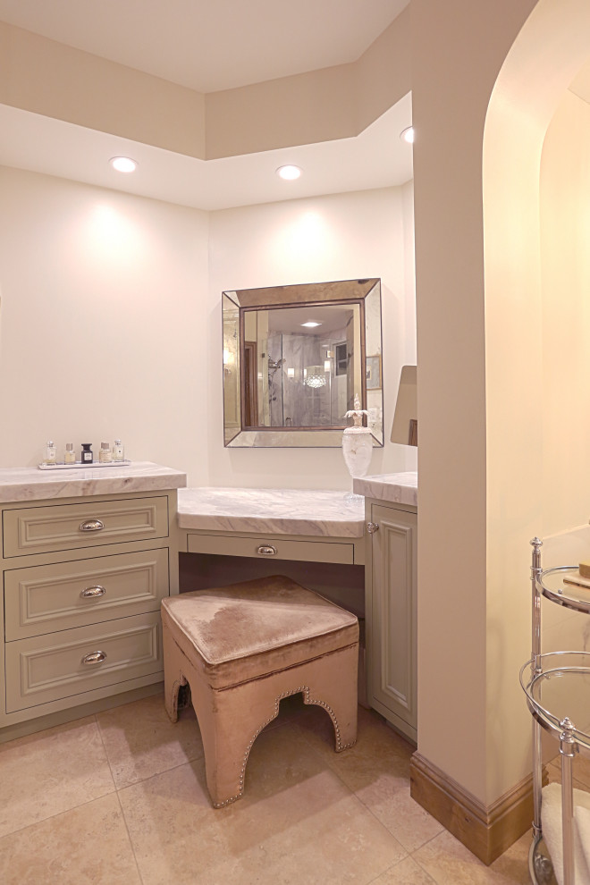 Photo of an expansive midcentury master bathroom in Orange County with recessed-panel cabinets, green cabinets, a freestanding tub, an alcove shower, a one-piece toilet, white tile, marble, yellow walls, ceramic floors, a console sink, quartzite benchtops, beige floor, a hinged shower door, white benchtops, a shower seat, a double vanity and a built-in vanity.