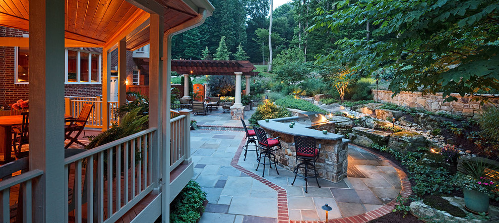 Inspiration for an expansive country backyard full sun driveway in DC Metro with concrete pavers.