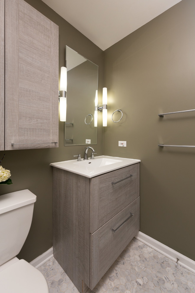 Photo of a mid-sized transitional 3/4 bathroom in Chicago with flat-panel cabinets, medium wood cabinets, an alcove shower, a two-piece toilet, gray tile, stone tile, beige walls, an integrated sink, marble benchtops and mosaic tile floors.