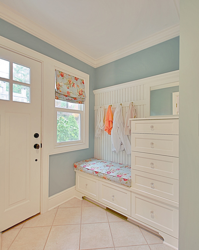 Photo of a small traditional mudroom in New York with blue walls, ceramic floors, a single front door and a white front door.