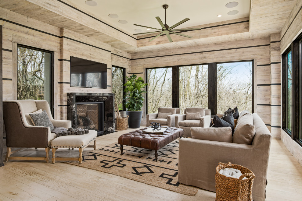 Transitional enclosed living room in Kansas City with beige walls, light hardwood floors, a standard fireplace, a stone fireplace surround and a wall-mounted tv.