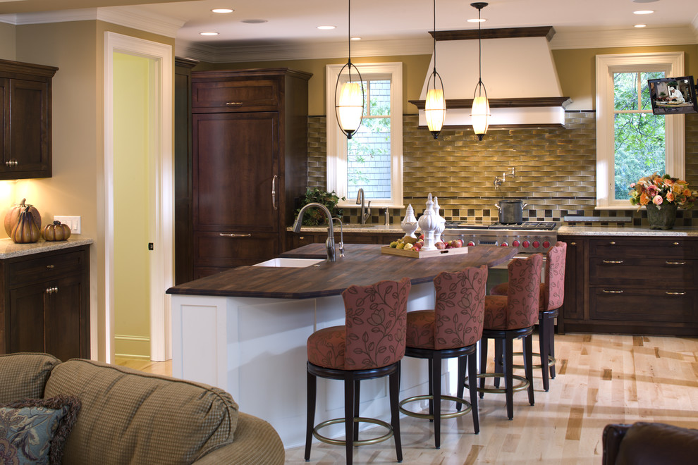 Photo of a traditional kitchen in Minneapolis with shaker cabinets, dark wood cabinets, wood benchtops and beige splashback.