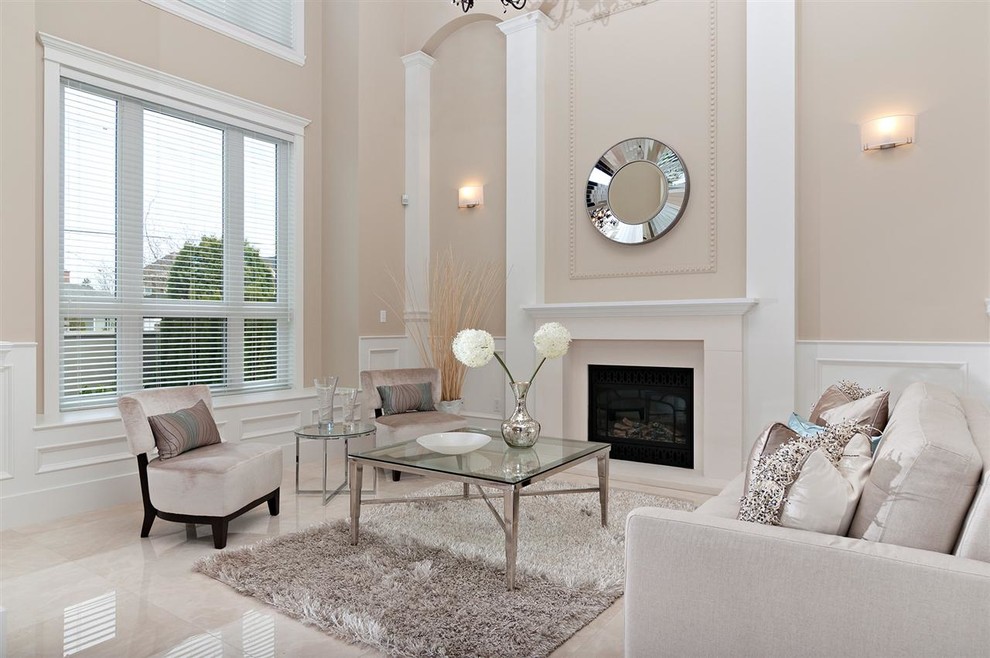 Photo of a transitional living room in Vancouver with beige walls, a standard fireplace, no tv and beige floor.