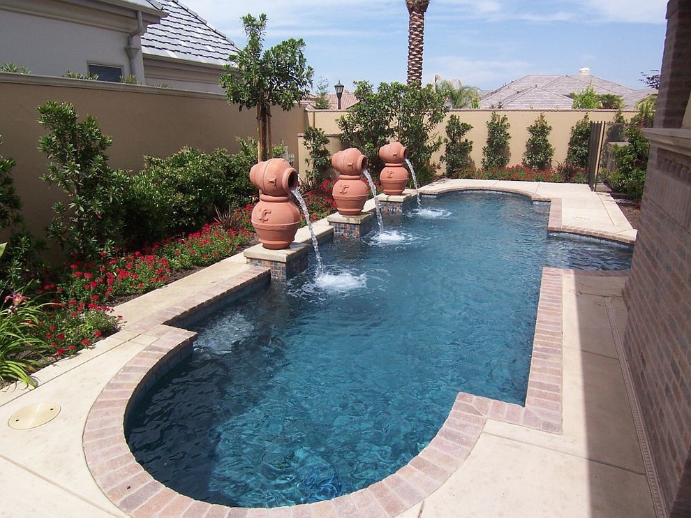 Inspiration for a mid-sized mediterranean backyard concrete and custom-shaped lap pool fountain remodel