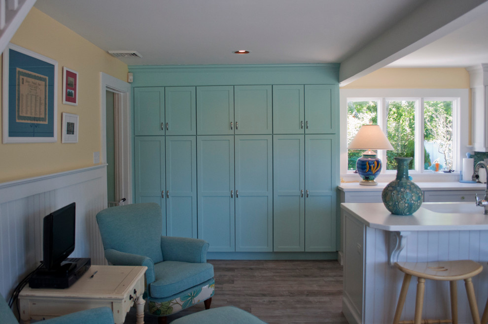 Design ideas for a mid-sized beach style l-shaped eat-in kitchen in Boston with an undermount sink, shaker cabinets, white cabinets, quartz benchtops, blue splashback, mosaic tile splashback, stainless steel appliances, porcelain floors and with island.