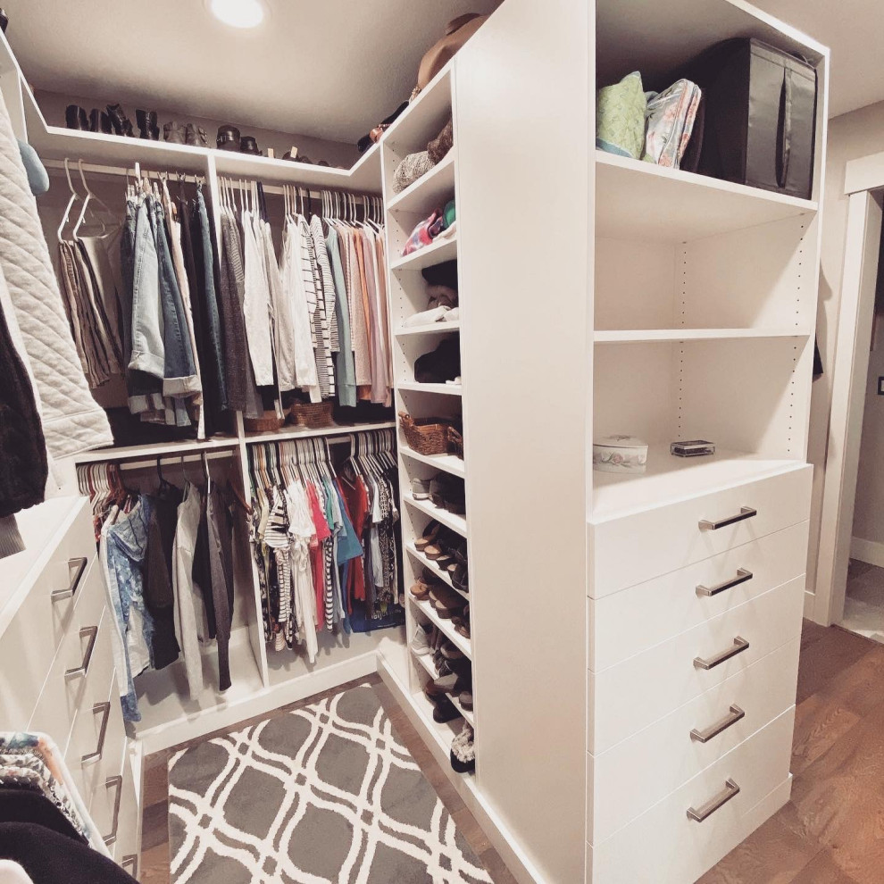 Inspiration for a modern gender neutral walk-in wardrobe in Portland with flat-panel cabinets.