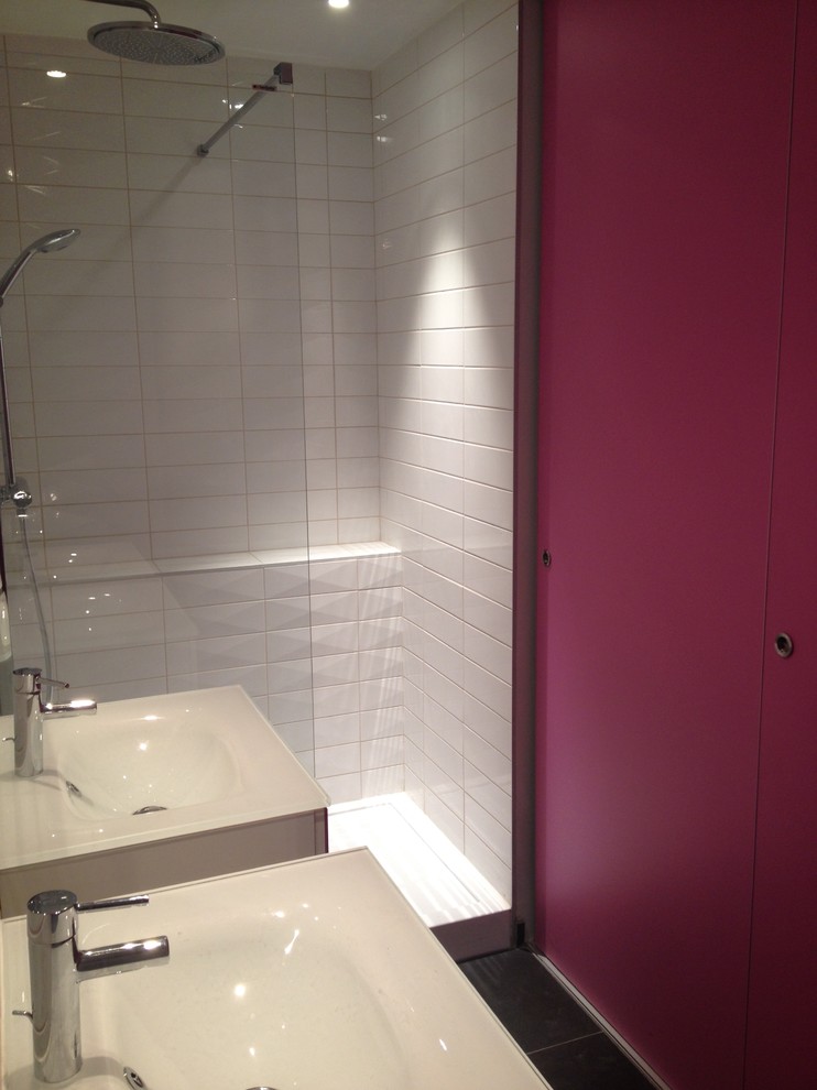 Photo of a mid-sized contemporary master bathroom in Lyon with flat-panel cabinets, white tile, ceramic tile, a console sink, white cabinets, a curbless shower, pink walls, cement tiles, tile benchtops, black floor and a hinged shower door.