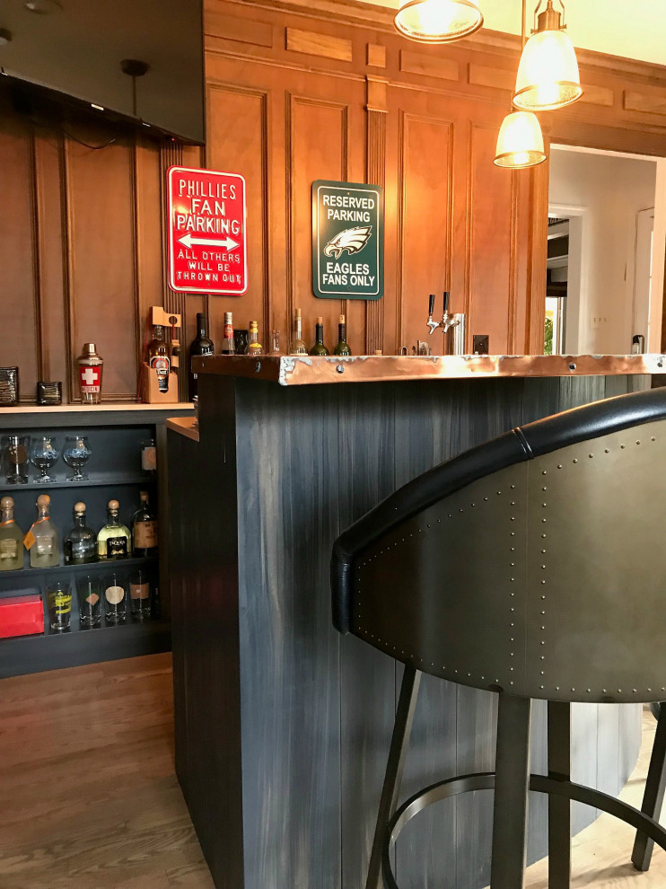Photo of a small industrial u-shaped seated home bar in Philadelphia with open cabinets, black cabinets, copper benchtops, timber splashback, medium hardwood floors and orange benchtop.