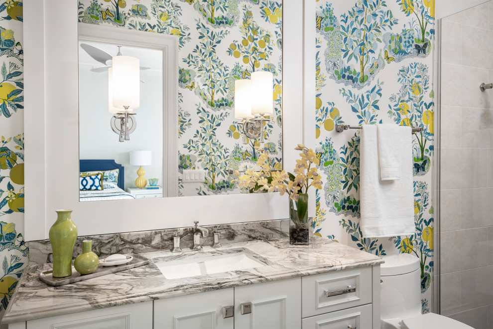 Photo of a large transitional kids bathroom in Other with recessed-panel cabinets, white cabinets, a one-piece toilet, white tile, porcelain tile, multi-coloured walls, ceramic floors, an undermount sink, marble benchtops, a hinged shower door and green benchtops.