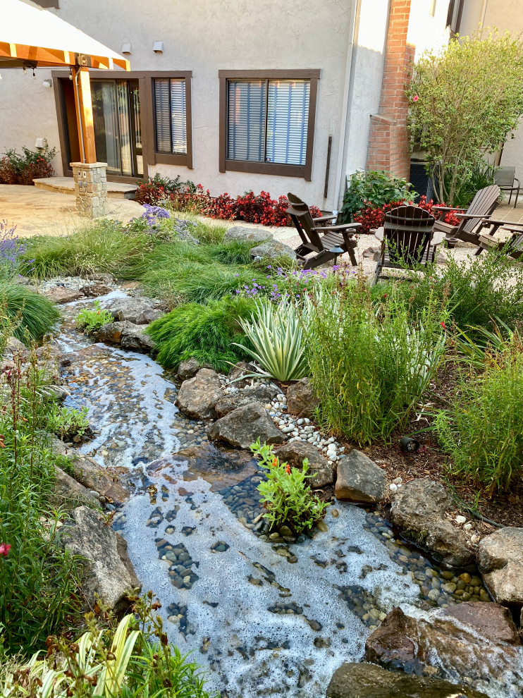 Photo of a mid-sized transitional backyard garden in San Francisco with with waterfall.