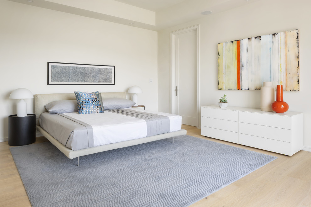 Design ideas for a large contemporary bedroom in San Francisco with white walls, light hardwood floors and beige floor.