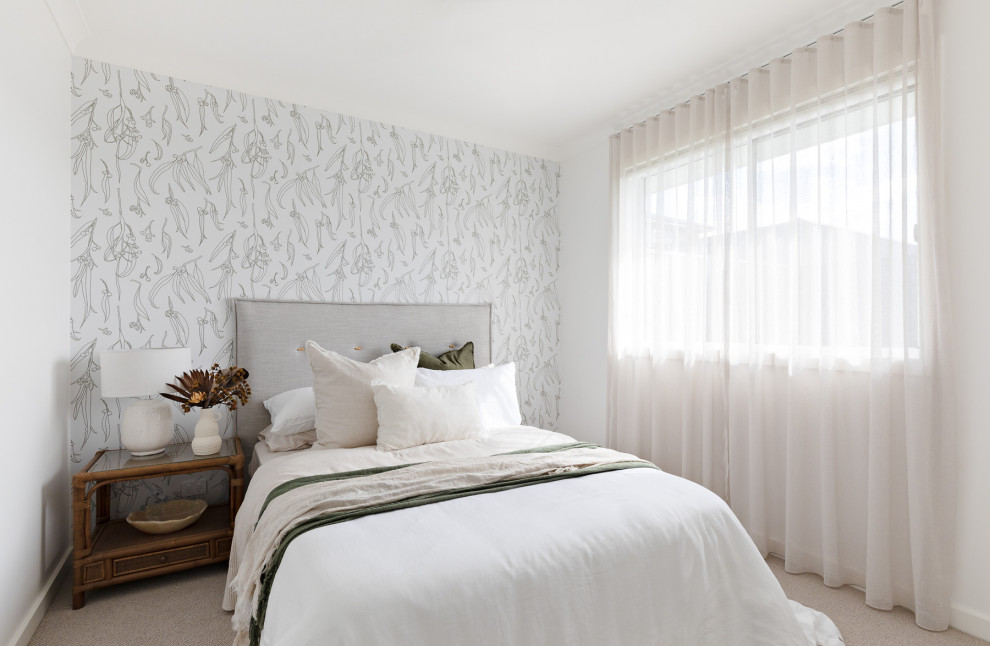 This is an example of a large country bedroom in Sydney with white walls and wallpaper.