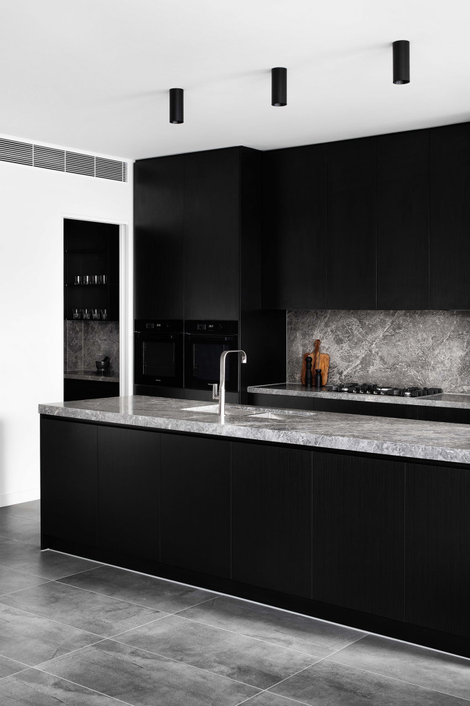 This is an example of a contemporary single-wall open plan kitchen in Melbourne with an undermount sink, black cabinets, marble benchtops, marble splashback, porcelain floors and with island.