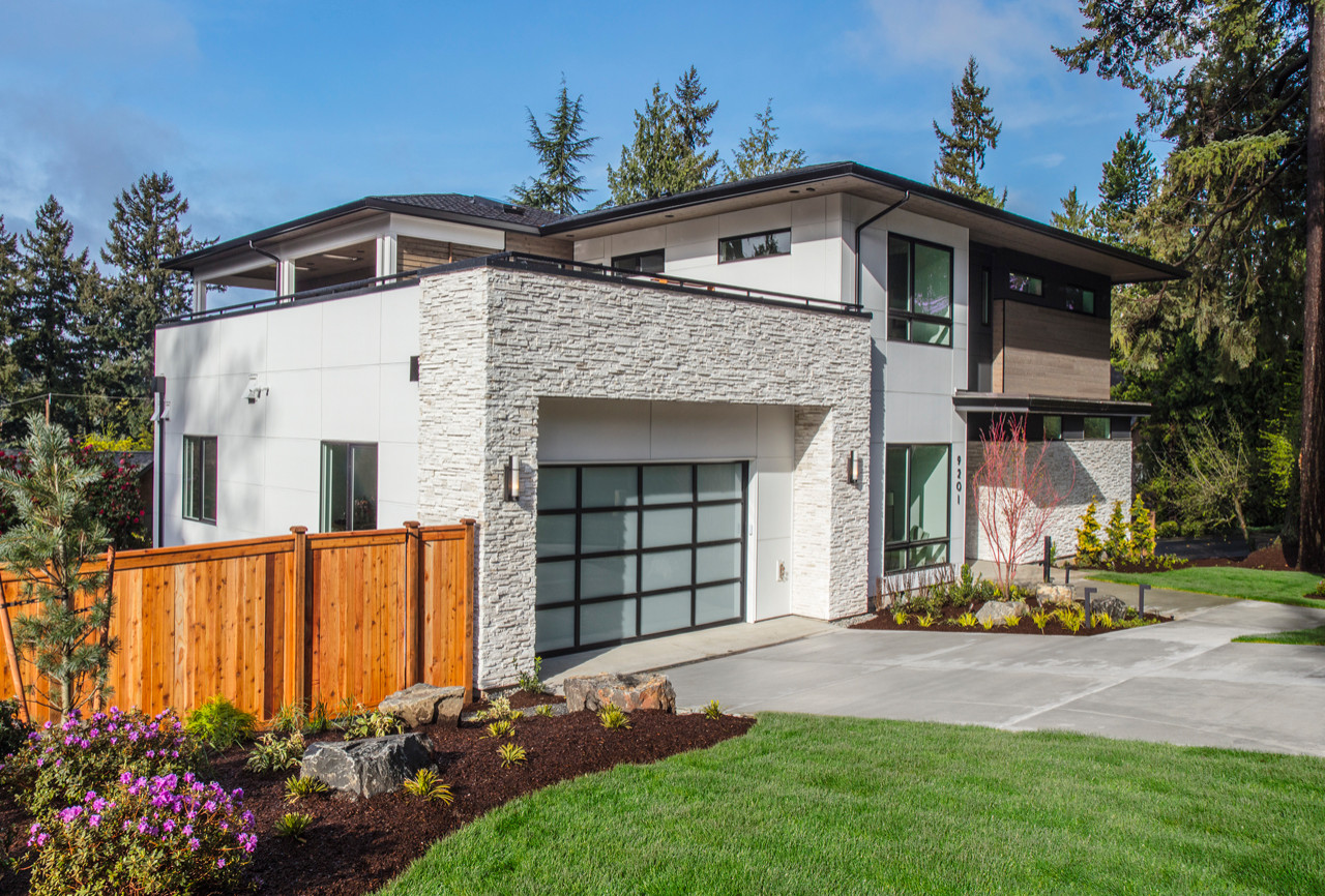 This great home is situated on a corner lot with amazing views of Meydenbauer Bay from several vantage points throughout the home.  The mix of exterior materials adds depth and interest to the exterio