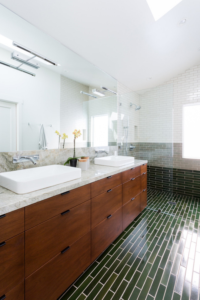 This is an example of a large contemporary master bathroom in Los Angeles with flat-panel cabinets, medium wood cabinets, an open shower, gray tile, green tile, white tile, white walls, a vessel sink, green floor and grey benchtops.