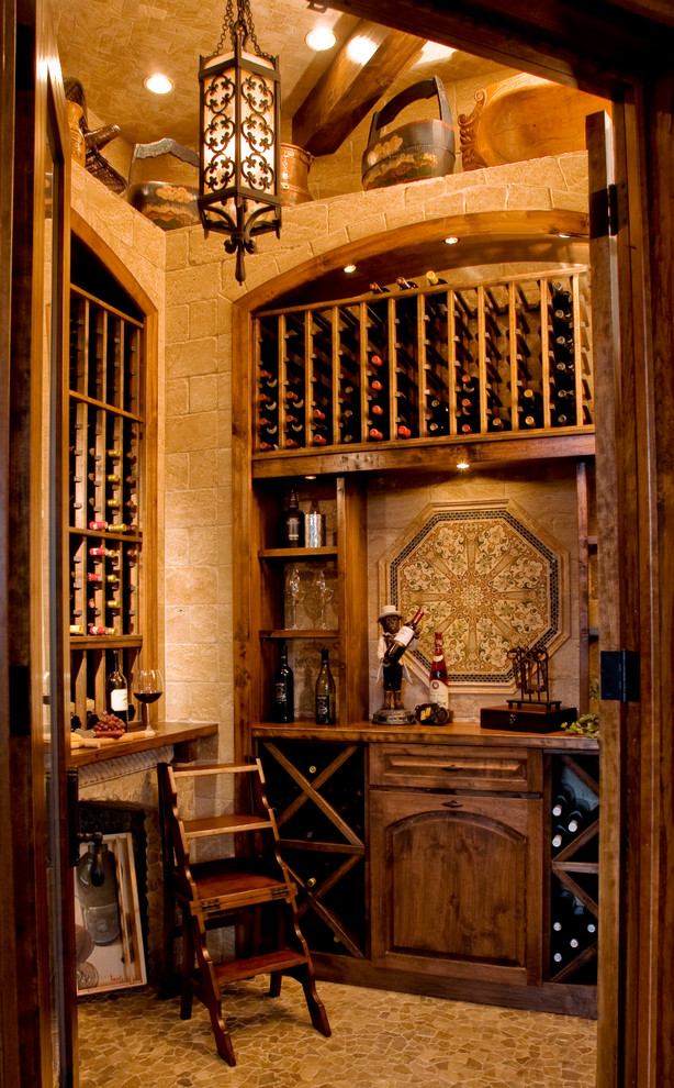 Mid-sized mediterranean wine cellar in Other with travertine floors, storage racks and yellow floor.