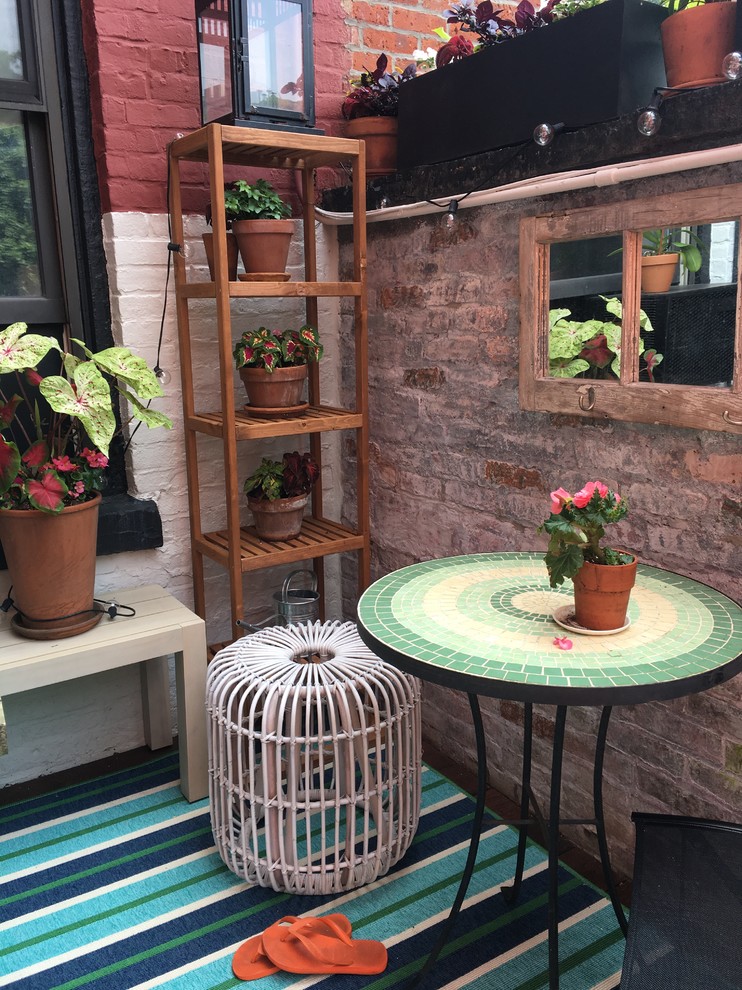 This is an example of a small beach style side yard deck in New York with a container garden and no cover.