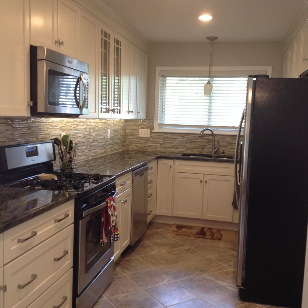 Eat-in kitchen - contemporary u-shaped porcelain tile and multicolored floor eat-in kitchen idea in Detroit with an undermount sink, shaker cabinets, white cabinets, granite countertops, multicolored backsplash, stainless steel appliances, no island and glass sheet backsplash