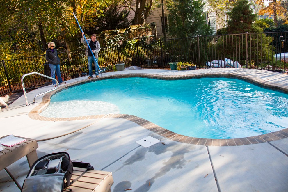 Photo of a small arts and crafts backyard custom-shaped natural pool in Charlotte with decking.