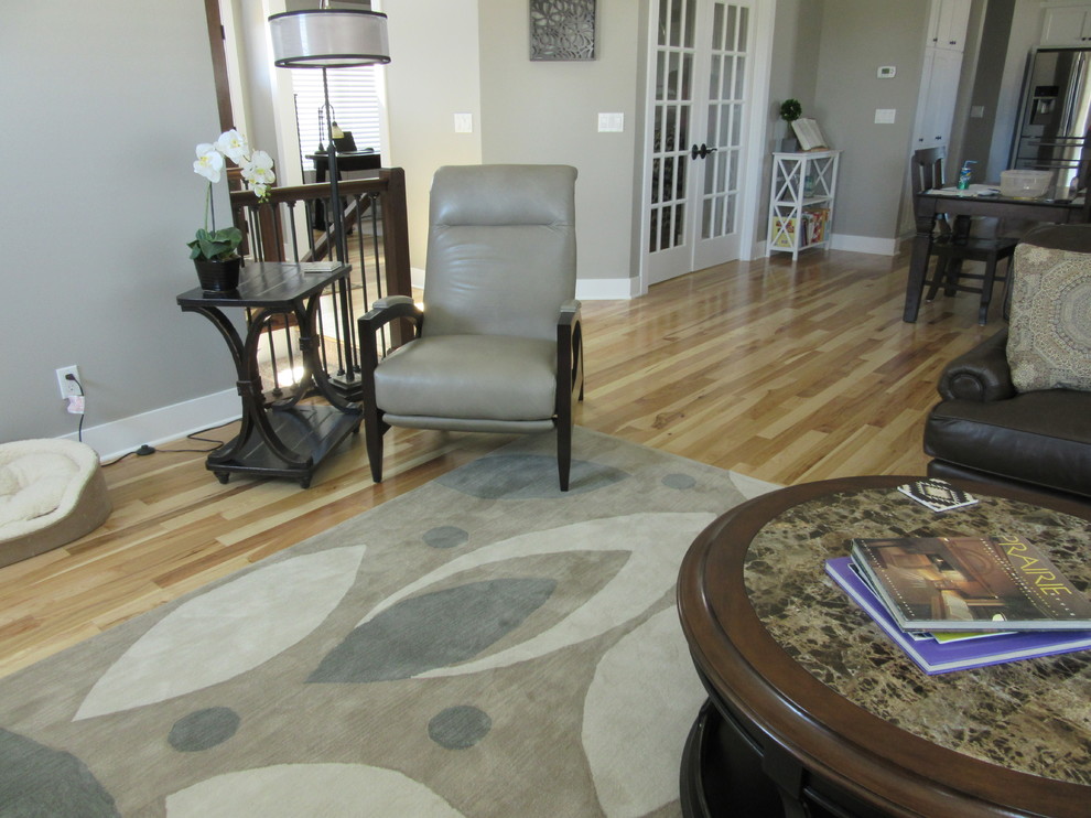 Inspiration for a mid-sized transitional open concept light wood floor home design remodel in Omaha with gray walls