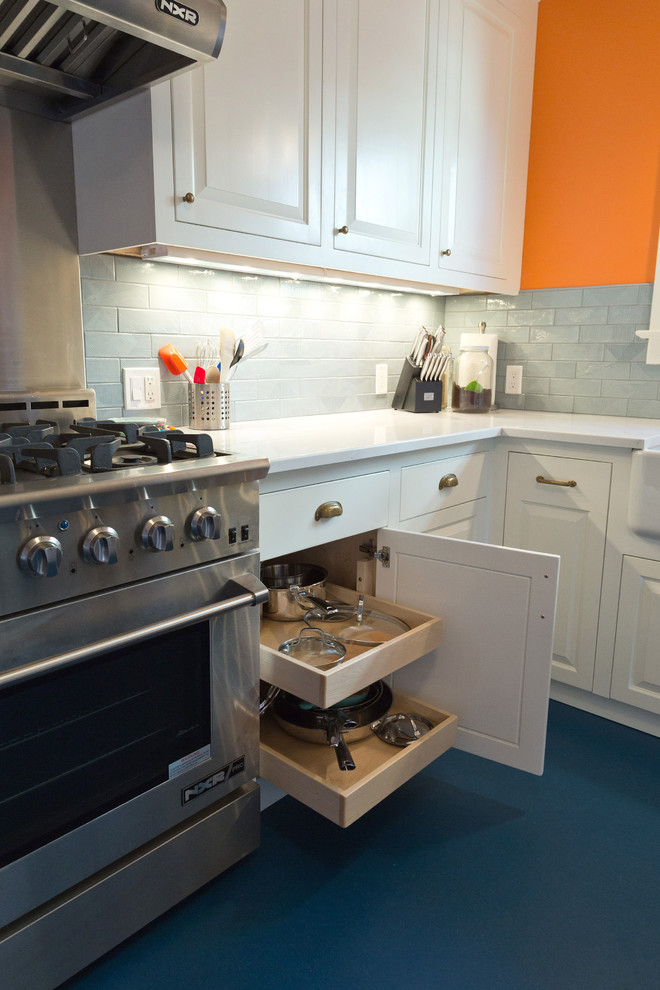 Small traditional l-shaped separate kitchen in Portland with a farmhouse sink, raised-panel cabinets, white cabinets, quartz benchtops, blue splashback, ceramic splashback, stainless steel appliances, linoleum floors, no island, blue floor and white benchtop.