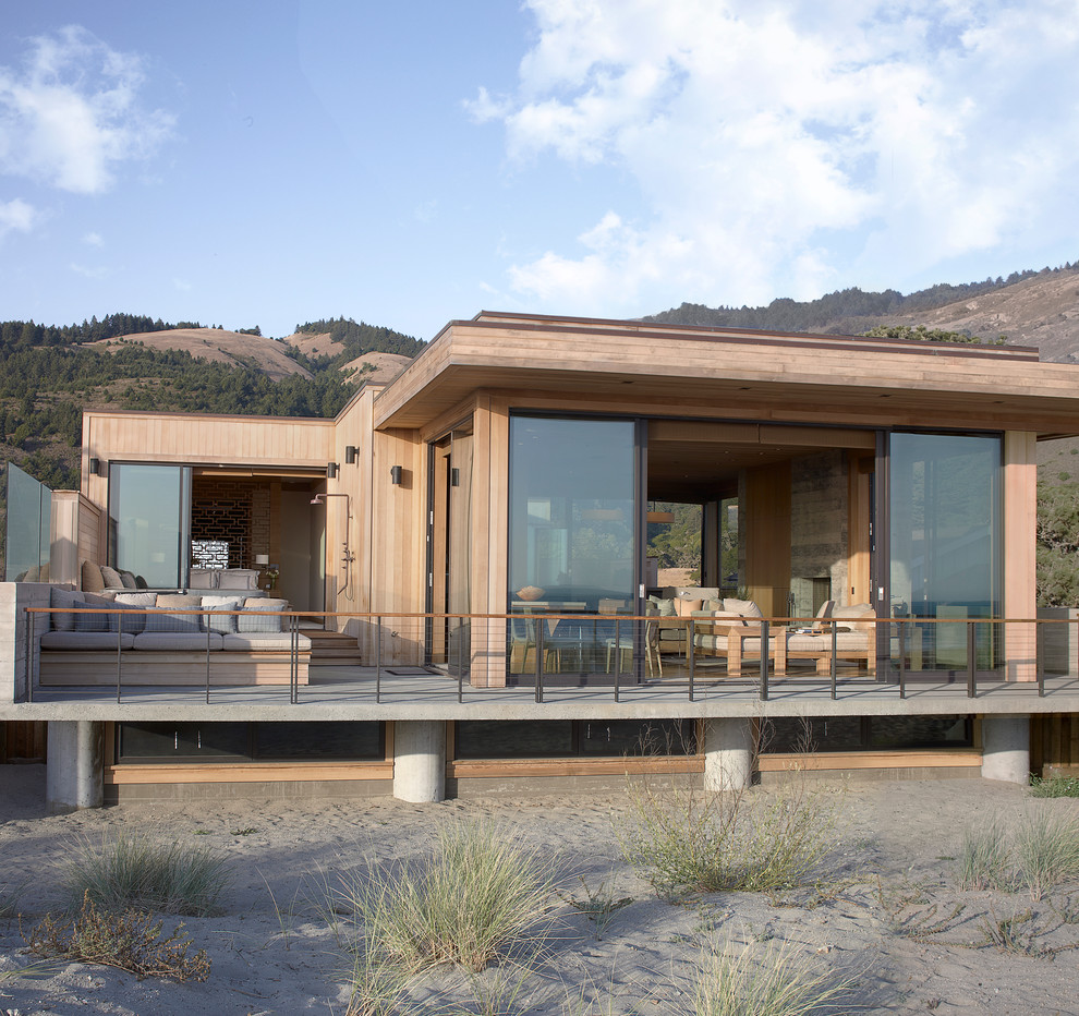 Mid-sized beach style one-storey exterior in San Francisco with wood siding and a flat roof.