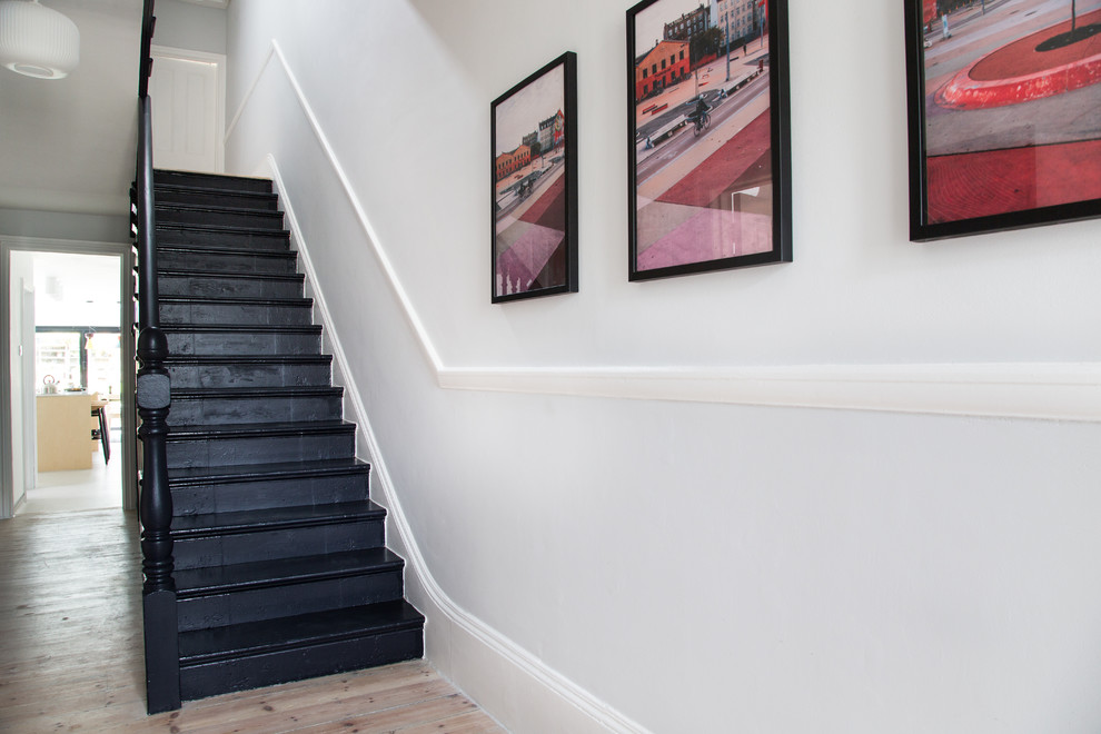 Design ideas for a small modern slate straight staircase in London with wood risers.